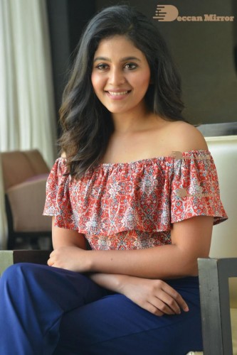 Telugu and Tamil Actress Anjali poses for pictures in Orange Off Shoulder Top and Jeans