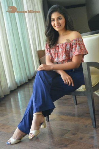 Telugu and Tamil Actress Anjali poses for pictures in Orange Off Shoulder Top and Jeans