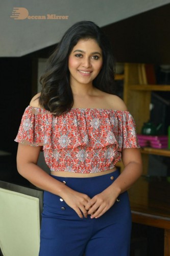 Telugu and Tamil Actress Anjali poses for pictures in Orange Off Shoulder Top and Jeans