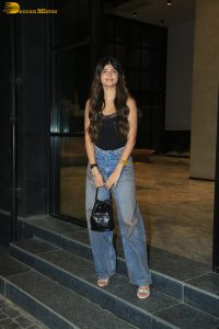 actress anjini dhawan in a black top and blue denim jeans