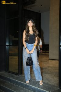 actress anjini dhawan in a black top and blue denim jeans