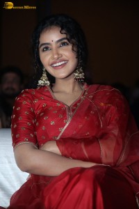 Actress Anupama Parameswaran in a red lehenga choli at a function