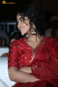 Actress Anupama Parameswaran in a red lehenga choli at a function