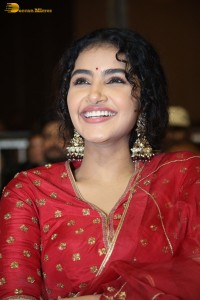 Actress Anupama Parameswaran in a red lehenga choli at a function