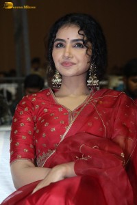 Actress Anupama Parameswaran in a red lehenga choli at a function