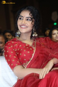 Actress Anupama Parameswaran in a red lehenga choli at a function