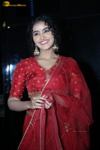 Actress Anupama Parameswaran in a red lehenga choli at a function