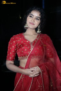 Actress Anupama Parameswaran in a red lehenga choli at a function