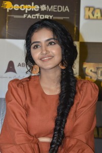 Actress Anupama Parameswaran in a reddish brown dress while attending a movie function