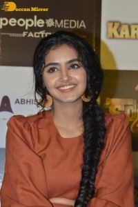 Actress Anupama Parameswaran in a reddish brown dress while attending a movie function