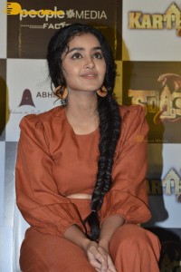 Actress Anupama Parameswaran in a reddish brown dress while attending a movie function