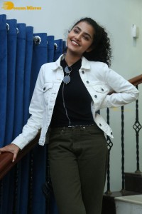 Actress Anupama Parameswaran in khaki pants and white jacket