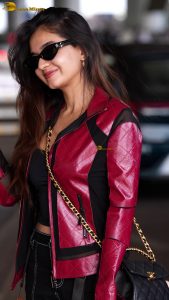 Indian tv and bollywood actress Anushka Sen cute in a maroon jacket at airport