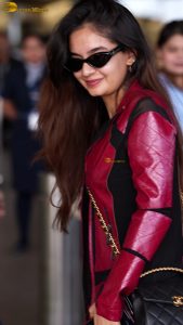 Indian tv and bollywood actress Anushka Sen cute in a maroon jacket at airport
