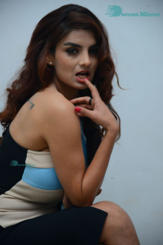 Actress Anveshi Jain posing for pictures in a blue dress