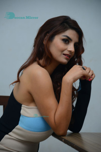 Actress Anveshi Jain posing for pictures in a blue dress