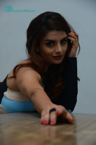 Actress Anveshi Jain posing for pictures in a blue dress