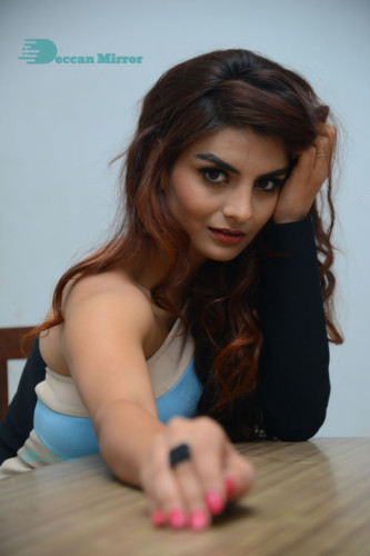 Actress Anveshi Jain posing for pictures in a blue dress