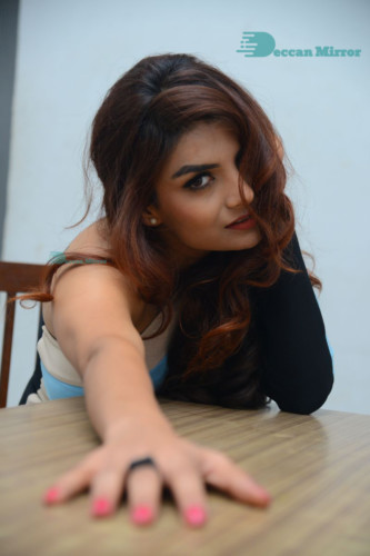 Actress Anveshi Jain posing for pictures in a blue dress