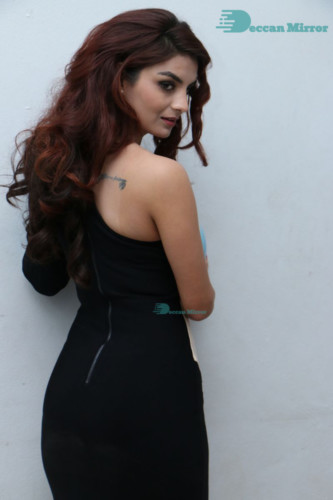 Actress Anveshi Jain posing for pictures in a blue dress