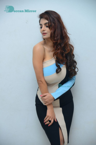 Actress Anveshi Jain posing for pictures in a blue dress