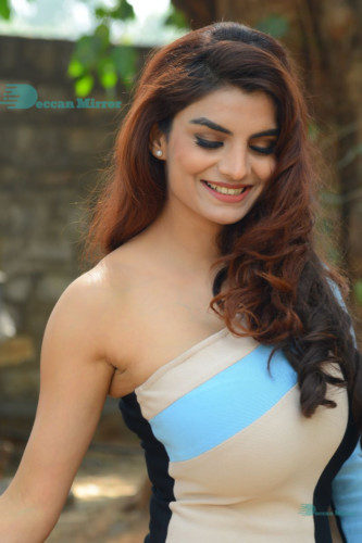 Actress Anveshi Jain posing for pictures in a blue dress