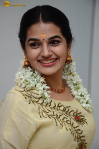 actress aparna janardanan cute looks in a light yellow salwar kameez