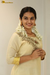 actress aparna janardanan cute looks in a light yellow salwar kameez