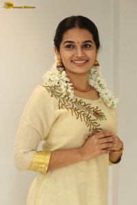 actress aparna janardanan cute looks in a light yellow salwar kameez