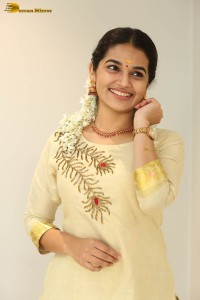 actress aparna janardanan cute looks in a light yellow salwar kameez