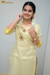 actress aparna janardanan cute looks in a light yellow salwar kameez