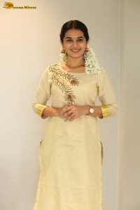 actress aparna janardanan cute looks in a light yellow salwar kameez