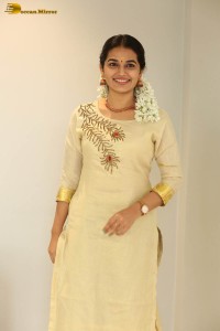 actress aparna janardanan cute looks in a light yellow salwar kameez