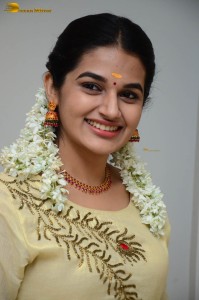 actress aparna janardanan cute looks in a light yellow salwar kameez