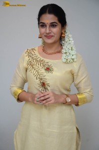 actress aparna janardanan cute looks in a light yellow salwar kameez