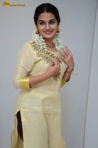 actress aparna janardanan cute looks in a light yellow salwar kameez