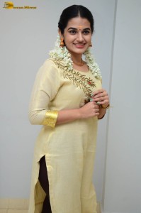 actress aparna janardanan cute looks in a light yellow salwar kameez