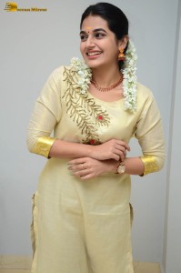 actress aparna janardanan cute looks in a light yellow salwar kameez
