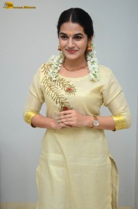 actress aparna janardanan cute looks in a light yellow salwar kameez