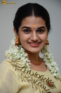 actress aparna janardanan cute looks in a light yellow salwar kameez