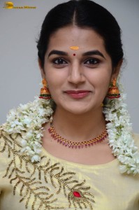 actress aparna janardanan cute looks in a light yellow salwar kameez