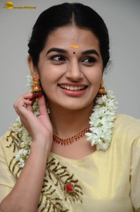 actress aparna janardanan cute looks in a light yellow salwar kameez