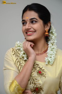 actress aparna janardanan cute looks in a light yellow salwar kameez