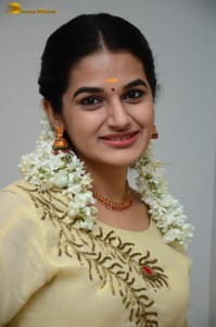 actress aparna janardanan cute looks in a light yellow salwar kameez