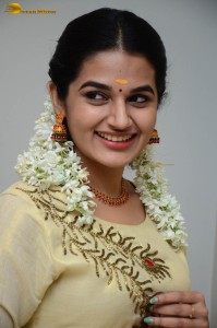 actress aparna janardanan cute looks in a light yellow salwar kameez