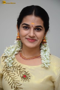 actress aparna janardanan cute looks in a light yellow salwar kameez