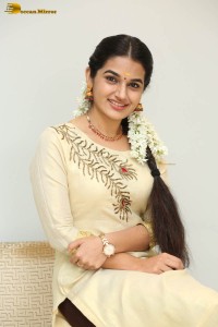 actress aparna janardanan cute looks in a light yellow salwar kameez