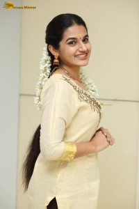 actress aparna janardanan cute looks in a light yellow salwar kameez