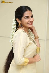 actress aparna janardanan cute looks in a light yellow salwar kameez