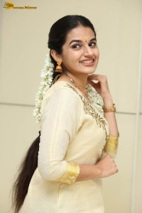 actress aparna janardanan cute looks in a light yellow salwar kameez
